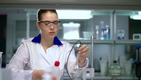 Female-scientist-working-with-equipment-in-chemical-laboratory
